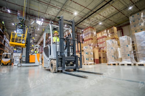 Preview: Forklift operator during work in large warehouse