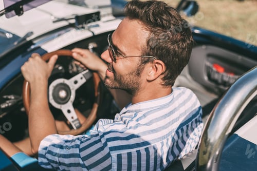 Preview: Man driving a convertible vintage car