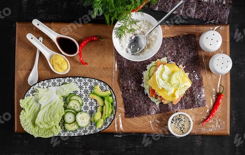 Preview: The process of making a creative sushi burger with salmon, fried egg, cucumber. avocado. Step 6