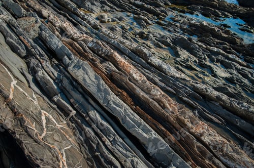 Preview: Geological line layers of stones in the section of the rock, layers on the rocks of the seashore.