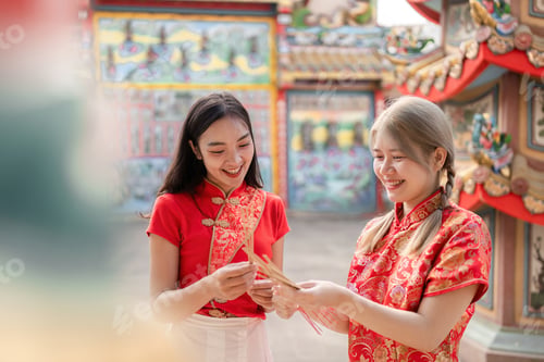 Preview: Celebrating chinese new year joyful friends exchanging wishes in a vibrant temple courtyard festive