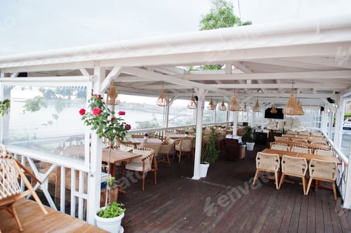 Preview: Terrace of a cafe by the sea in early morning.