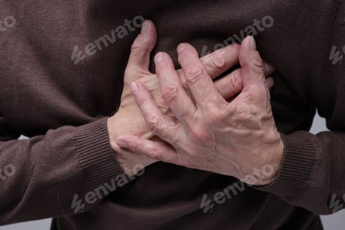 Preview: Heart attack. Senior man suffering from pain in chest, closeup