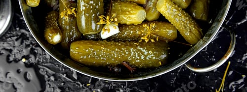 Preview: Banner of Canned cucumbers in a metal pan.