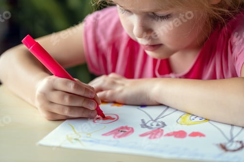 Preview: Child drawing a picture with colored markers, sitting at the table