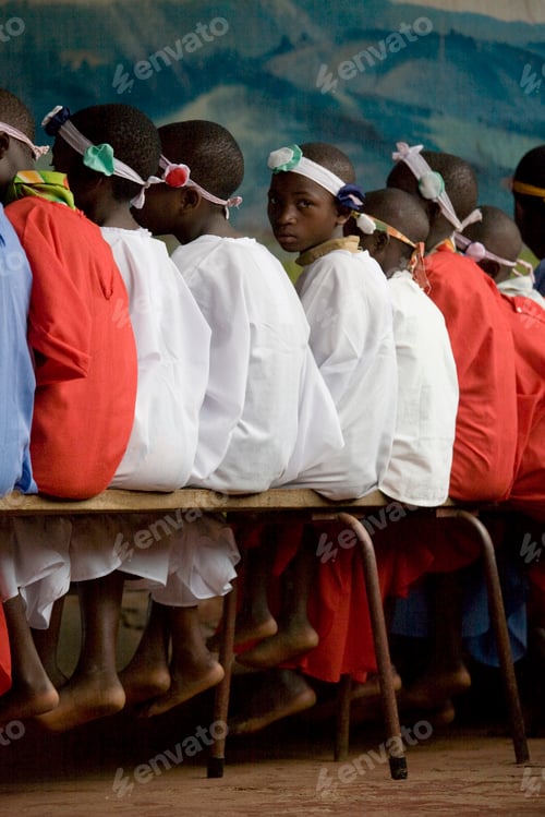 Preview: Children in traditional attire seated side by side at a cultural event