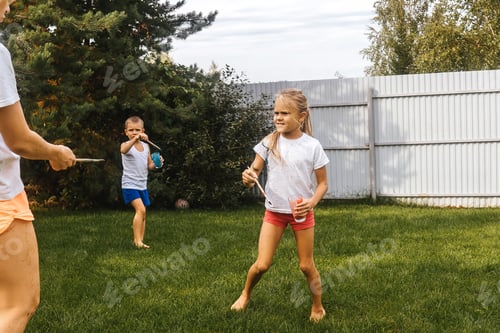 Preview: Happy family in garden. People staine watercolors each other, fun leisure activities with children.