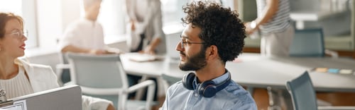 Preview: Businessman working laptop while sitting in modern office on colleagues background
