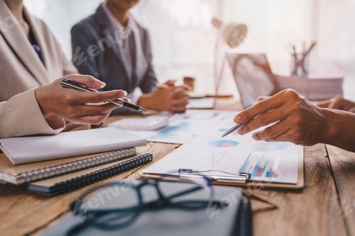 Preview: Financial analyst analyzes business finance reports on laptop and graph documents during corporate m