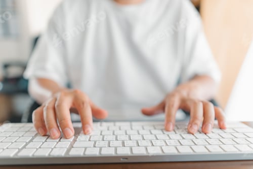 Preview: Man working at home, hands pressing computer keyboard, working at home