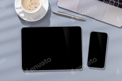 Preview: Blank screen smartphone and tablet on a desk