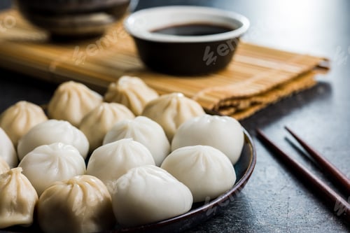 Preview: Xiaolongbao, traditional steamed dumplings. Xiao Long Bao buns on plate.