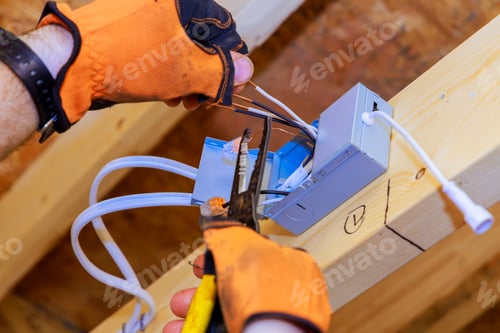 Preview: In new home construction, an electrician installs a power junction box for LED recessed ceiling