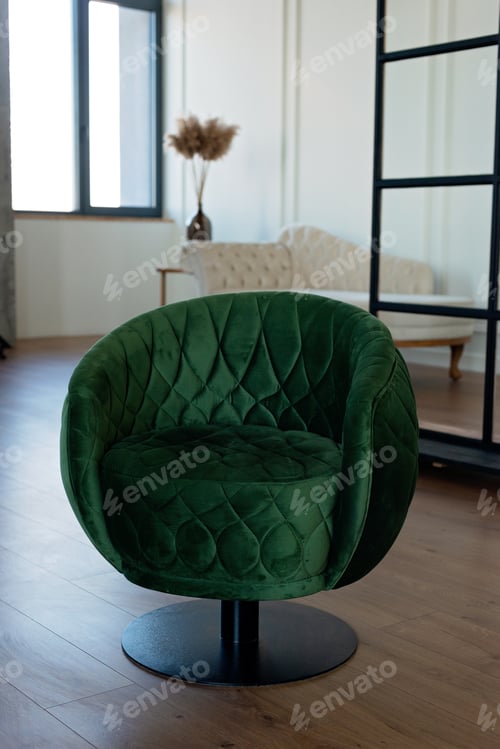 Preview: Stylish round green velvet armchair in a modern interior. Soft selective focus.