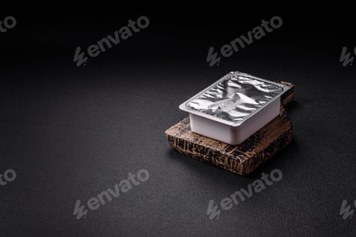 Preview: Rectangular plastic box with yogurt or cheese hermetically sealed with a foil lid