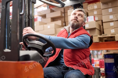Preview: Worker using forklift to load cargo on shelves