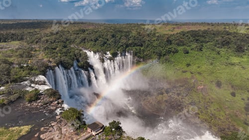 Preview: Kalandula Waterfall cascading beautifully in Angola with a rainbow forming in the mist