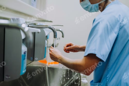 Preview: Unrecognizable doctor washing hands before operating