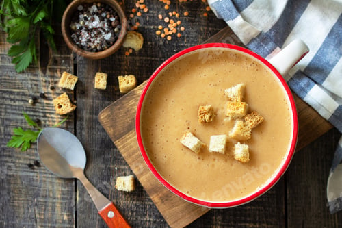 Preview: Oriental or Arabic cuisine. Hot lentil puree soup on a rustic wooden table. Top view flat lay.