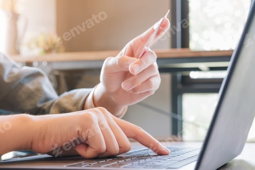 Preview: Online payment,woman's hands holding credit card and using computer for online shopping. Cyber