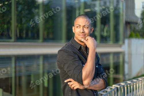 Preview: Cool businessman standing outside a financial building