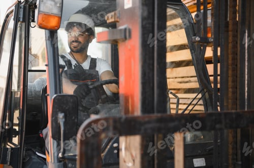 Preview: Warehouse worker driving forklift carrying lumber in timber yard
