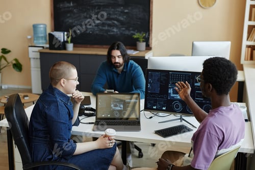 Preview: Young African American male IT engineer explaining something to female colleague