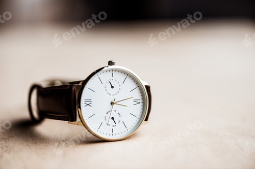 Preview: Elegant Wristwatch with Leather Strap on Light Surface