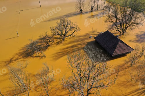 Preview: Aerial view of sinking village house in the middle of toxic mine decanting lake