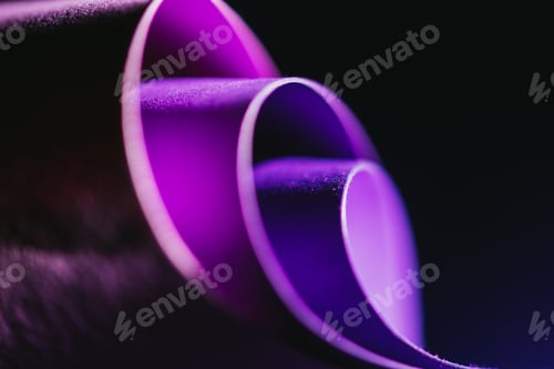 Preview: close up view of arcs of purple paper on black