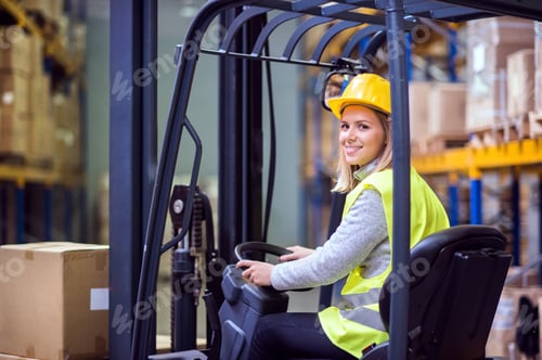 Preview: Woman warehouse worker with forklift.