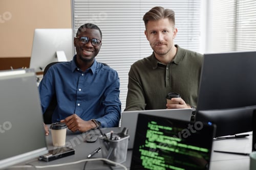 Preview: Two Diverse Programmers in Office Smiling at Camera