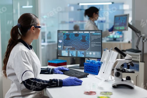Preview: Researcher biochemist woman analyzing virus expertise working at coronavirus treatment