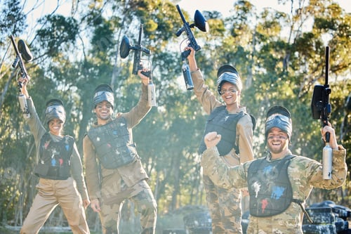 Preview: Team, paintball and portrait in celebration for winning, victory or achievement on the battlefield