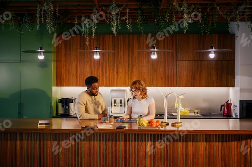 Preview: Interracial colleagues at eco friendly workspace discussing wind power