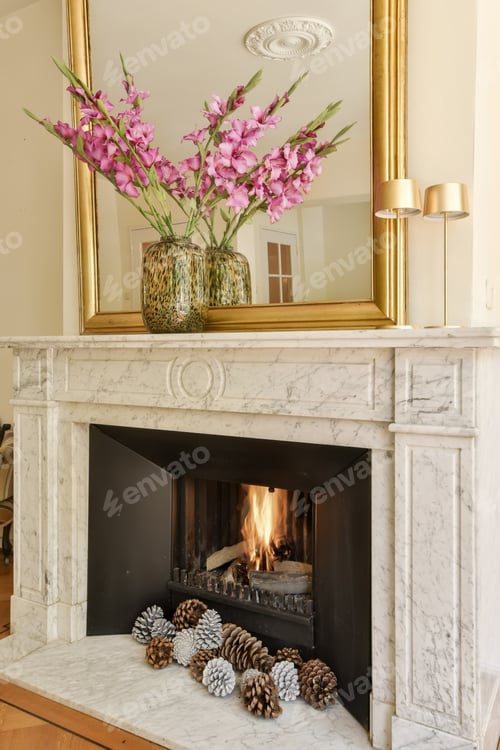 Preview: a fireplace mantel with pine cones and a mirror