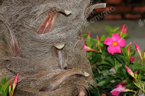 Preview: Hairy Palm Tree Trunk With Flowers Around It.