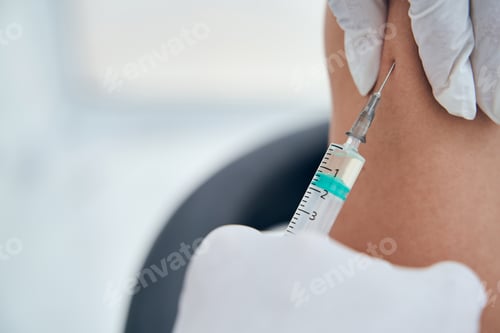 Preview: Focused photo on syringe doing covid vaccination