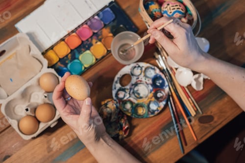 Preview: Hands painting easter eggs