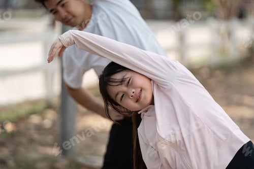 Preview: Father and Daughter Enjoying Outdoor Exercise Together in a Park on a Sunny Day