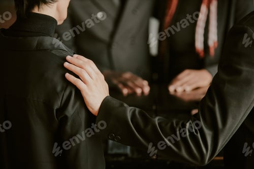 Preview: Unrecognizable Hand Comforting Woman at Funeral