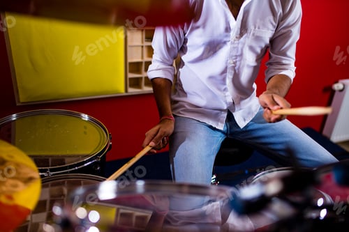 Preview: indian man playing the drums sticks close-up in recording studio