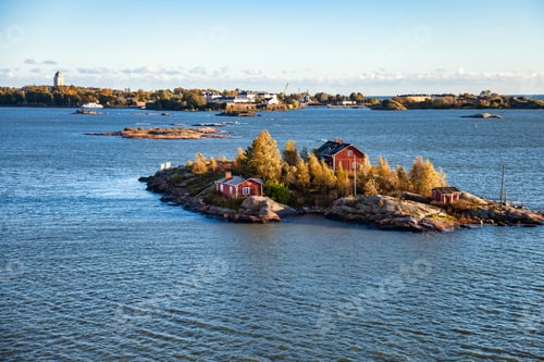 Preview: Serene view of small cabins on an island surrounded by water island in archipelago