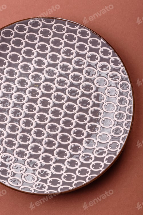 Preview: Empty ceramic plate on a monochrome brown background