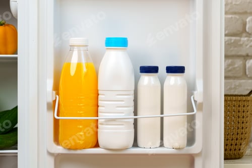 Preview: White Milk Bottles Stored in a Refrigerator Door Shelf