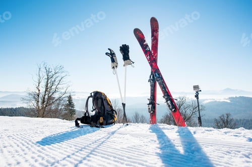 Preview: Skis skiing poles and backpack on the mountain
