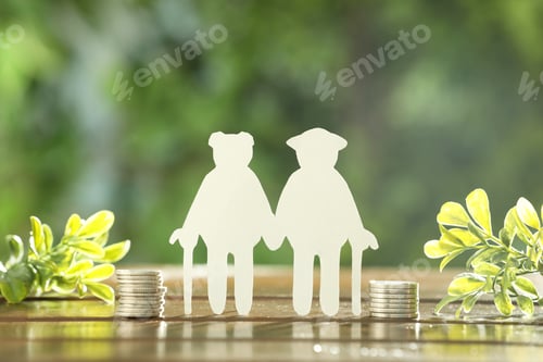 Preview: Pension savings. Figure of senior couple, stacked coins and green twigs on wooden table outdoors