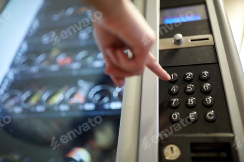 Preview: hand pushing button on vending machine keyboard