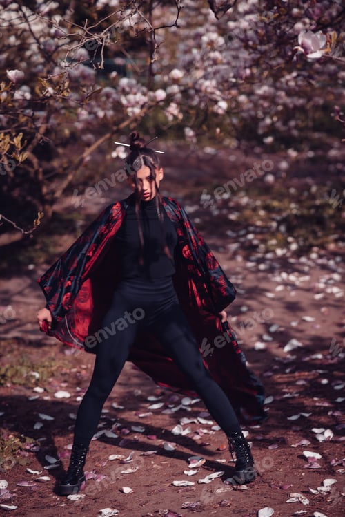 Preview: Beautiful young woman wearing black kimono with cherry blossoms, sakura view