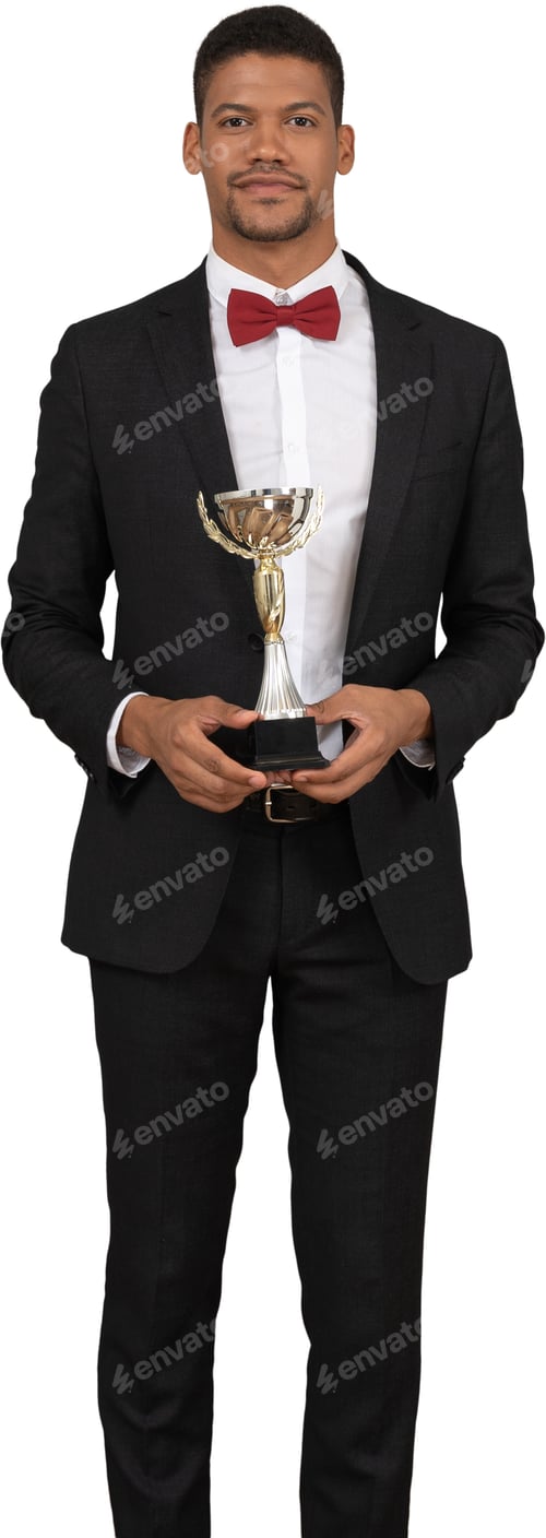 Preview: a man in a suit and bow tie holding a trophy